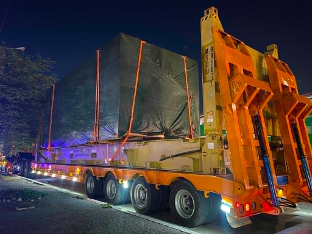 Heavy-haul trailer carrying oversized cargo at night